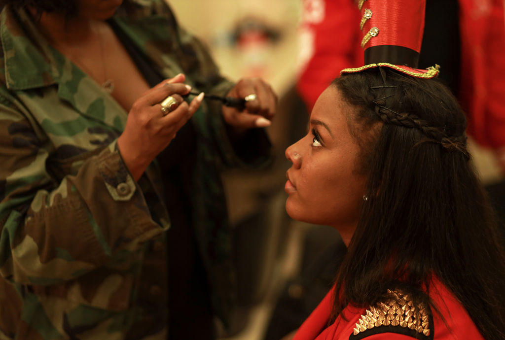 Tatyana Presley of Delta Sigma Theta Sorority has make-up applied